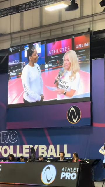 Coach April honored at the AUprovolleyball October 18 match seen here being interviewed on the big screen and live on TV.