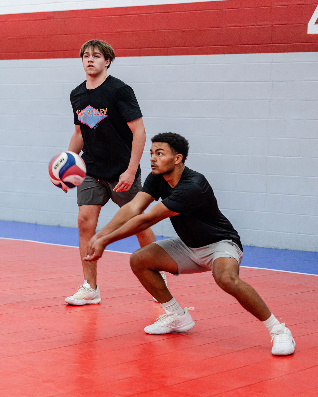 A good passer in volleyball faces the net, drops the inside shoulder, angles their platform, avoids turning to face the target, keeps shoulders facing the net. 